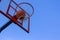 A basketball in a net on a blue sky background. The ball hit the ring.