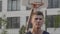 Basketball player dribbles the ball in urban court