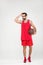 basketball player in red sportswear and retro glasses posing with ball,