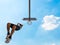 Basketball player seen from below under a blue sky