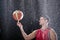 Basketball player spinning ball on a big rain