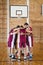 Basketball players forming a huddle