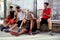 Basketball players take a break sitting on a low wall
