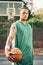 Basketball portrait, sports game and man training for professional fitness event on court during summer. African athlete