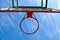 Basketball ring on the background a blue sky with white clouds. Basketball hoop on a shield on an outdoor sports ground. Basketbal