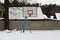 Basketball shield on an empty sports ground under the snow