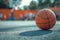 Basketball sits on court, blurred in background