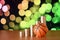 Basketball and stacks of golden coins in growth graph on the blurred bokeh background