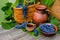 Baskets and bowl with grapes. Clay jar and cup with wine stand on on rustic wood. Wine making