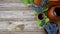 Baskets and bowl with grapes beside Jar and cup with wine stand on rustic wood. Wine making background. Top view