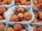 Baskets of fresh juicy peaches ripe and ready to eat for sale at the market