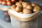 Baskets with potatoes and onions on shelf. Orderly storage