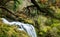 Basque waterfall in lush green hilly woodland