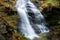 Basque waterfall in lush green hilly woodland