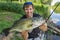 Bass fishing. Fisherman holding largemouth perch fish