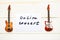 Bass guitar, electric guitar and card with message Online Concert on wooden background.