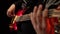 Bass guitar. Man fingers fingering the strings the musician . Close up. Black background