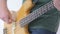 Bass guitar player fingers on the strings close-up isolated on white