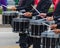 Bass section of a marching band drum line warming up for a parade