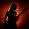 Bass Serenade: Silhouetted Female Bassist Conjures Deep Musical Resonance