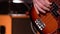 Bassist. Defocus on a male hand playing bass