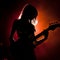 Bassline Serenity: Silhouetted Female Bassist Grooves in Musical Twilight