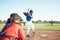 Bat, baseball and person swing at ball outdoor on a pitch for sports, performance and competition. Behind athlete or
