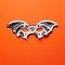 Bat-mask and vampire fangs on an orange background