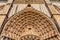 Batalha, Portugal. Close-up of the tympanum, archivolts and lintel of the Portal of Batalha Abbey aka Monastery of Santa Maria da