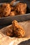 Batch of Crispy Homemade Fried Chicken on a Rustic Wooden Table