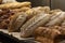 Batch of fresh baked buns and loafs on a market counter