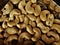 Batch of pale colored roasted and salted cashew nuts closeup macro photograph