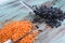 Batch of yellow lentils, black haricot beans scattered on spoons