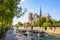 A bateau-mouche cruising on the Seine river in front of Notre-Dame de Paris cathedral