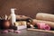 Bath accessories, soap, a bath towel, washcloth, sea salt, orange sticks, a candle, a wooden comb, shampoo are decorated with rose