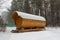 Bath barrel on the background of a winter coniferous forest. The first  snow is falling