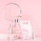 Bath cosmetics products and accessories in elegant pastel pink color - massage rose oil, bath salt, cream, soap, perfume, towel.