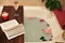 Bath with flower petals. Book, candles and glass of wine on a wood tray. Organic Spa Relaxation in comfort cozy bathroom