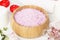 Bath salt with aroma of a rose in a wooden bowl, petals and a fr