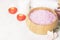 Bath salt with aroma of a rose in a wooden bowl, petals and a fr