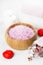 Bath salt with aroma of a rose in a wooden bowl, petals and a fr