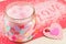 Bath salt in a jar next to a pink plaid heart