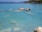 Bath in the sea with tourists and vacationers at the thermal healing hot springs of the Greek resort of Methana on the Peloponnese