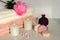 Bath settingin white and pink colors. Towel, aroma oil, flowers, soap. Selective focus, horizontal.