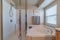 Bath and a shower cubicle in a minimalistic bathroom