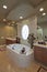Bath and sink with circular window in luxurious bathroom