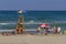 Bathers sunbathing on the shore of the beach