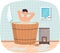 Bathhouse or banya at home interior design. Guy in barrel resting in sauna. Man in hot steam