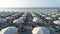 Bathhouse in summer. Beach equipped with umbrellas, deck chairs and sun loungers