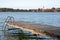 Bathing place with jetty and bathing entrance at Riegsee near Murnau bavaria Germany with a view of an idyllic village